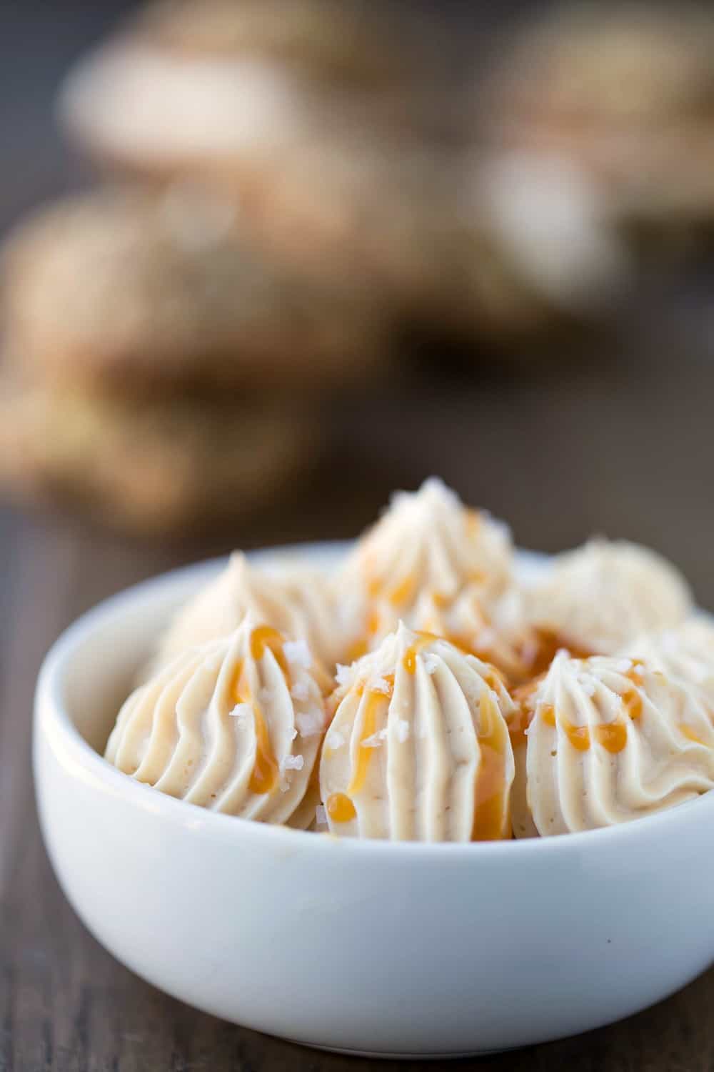 Piped caramel frosting in a white dish.