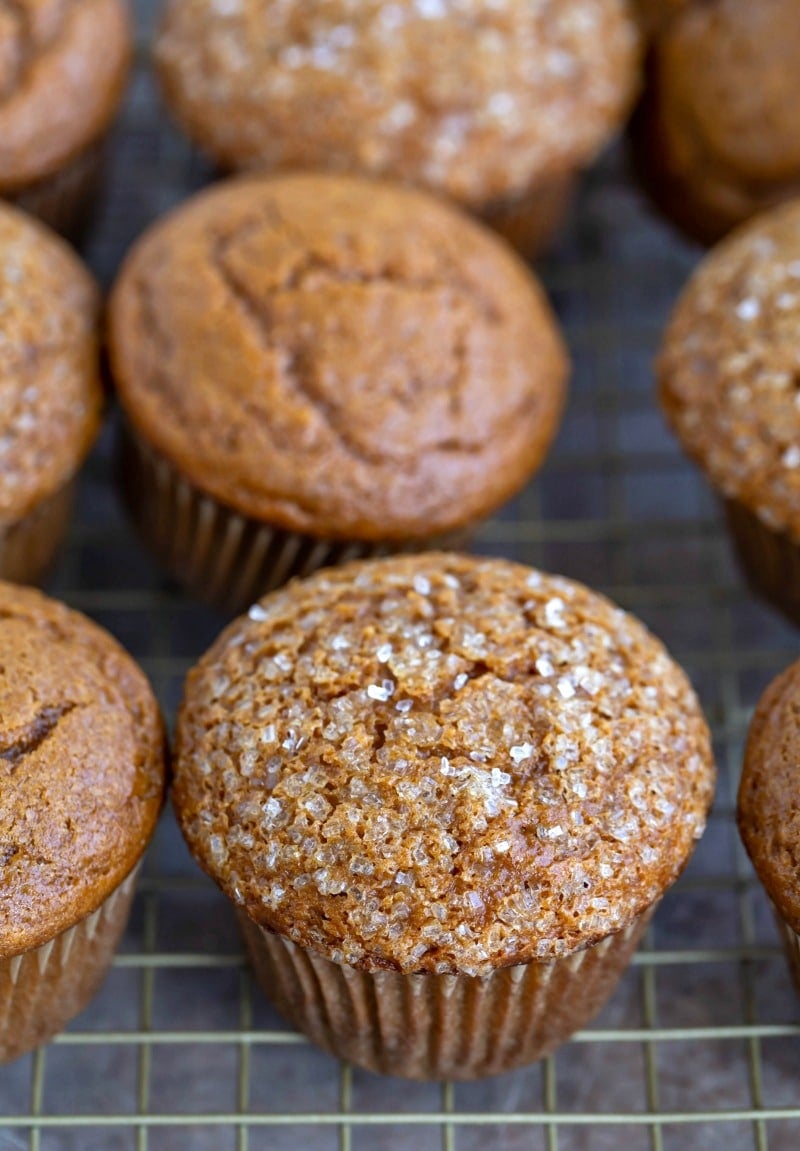 Gingerbread muffins topped with coarse sugar on a wire cooling rack