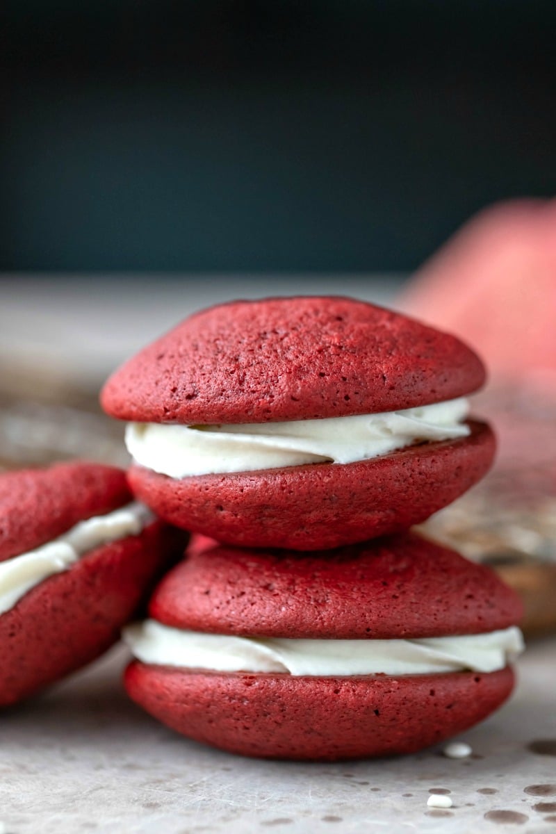 Two red velvet whoopie pies stacked on top of each other