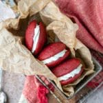 Red velvet whoopie pies in a metal tin