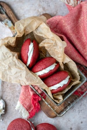 Red velvet whoopie pies in a metal tin