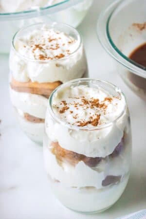 Two glasses of hot chocolate tiramisu on a marble background