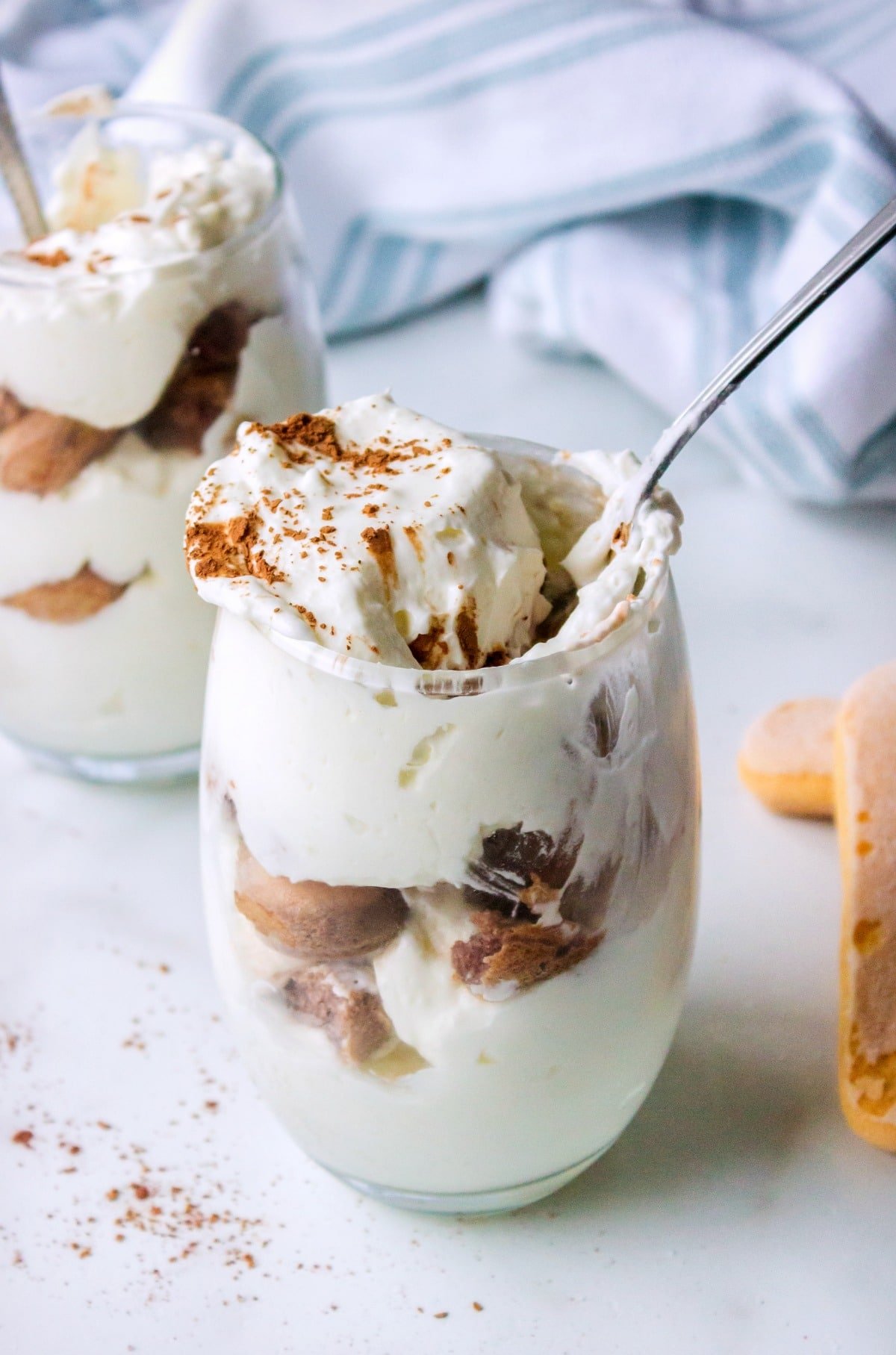 Spoon pulling a bite of hot chocolate tiramisu out