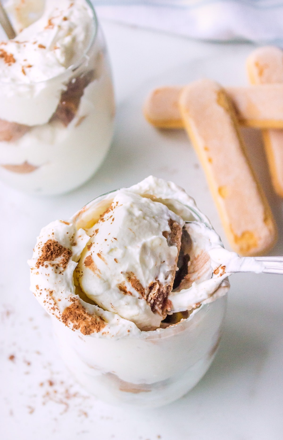 A spoon taking a bite out of hot chocolate tiramisu