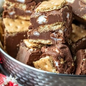 Tin of s'mores fudge on a wooden cutting board