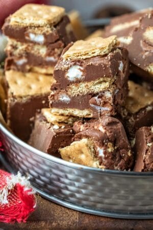 Tin of s'mores fudge on a wooden cutting board