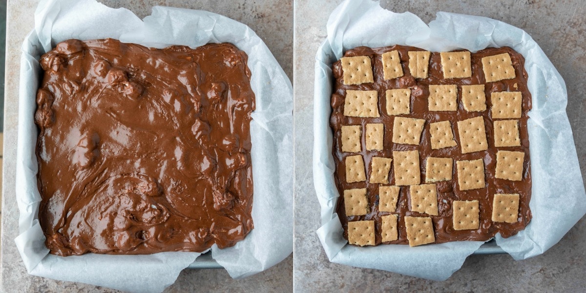 Metal baking pan lined with parchment paper and filled with s'mores fudge