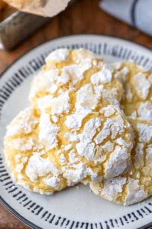 Lemon coconut cookies on a black and whit plate