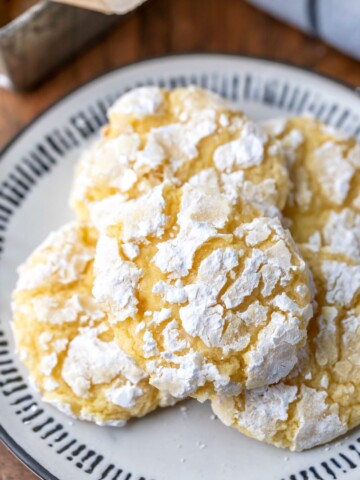 Lemon coconut cookies on a black and whit plate