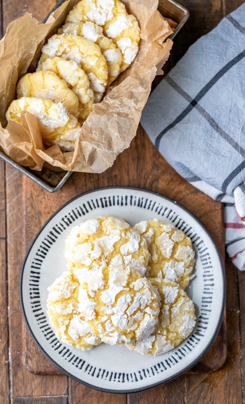 Plate with lemon coconut cookies on a wooden cutting board