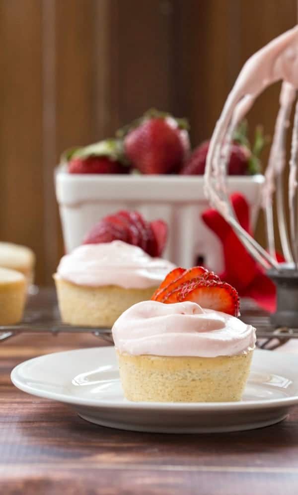 Strawberry Cream Cheese Frosting on a white cupcake topped with strawberry slices