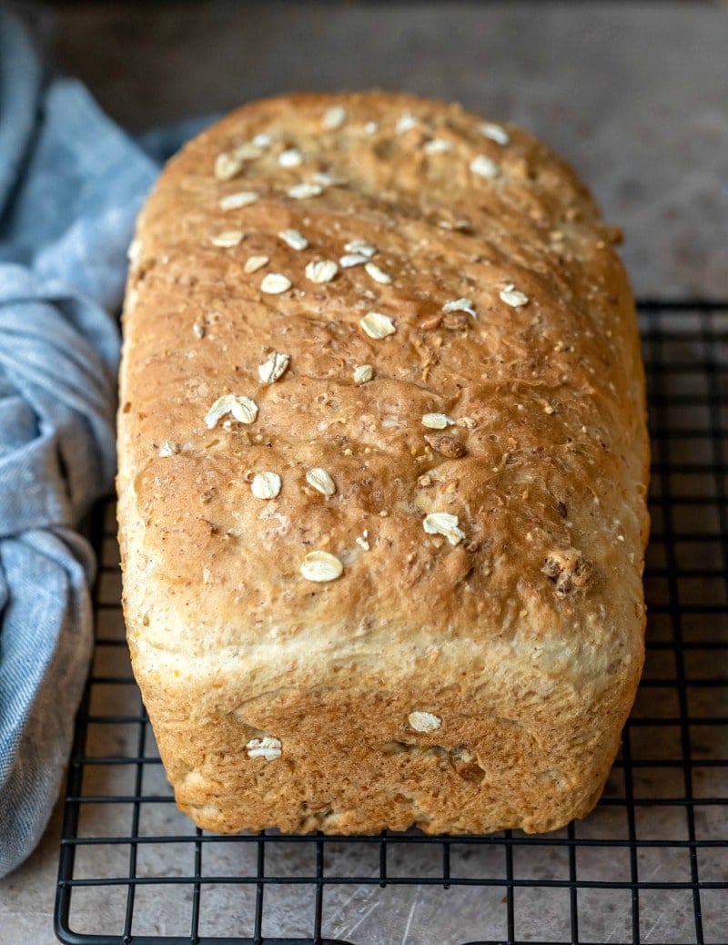 Loaf of multigrain bread on a wire cooling rack