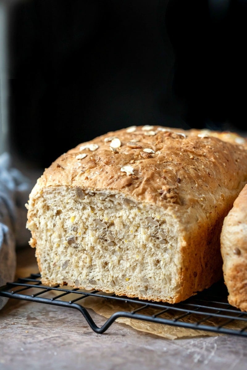 Loaf of multigrain bread with a slice cut off the end