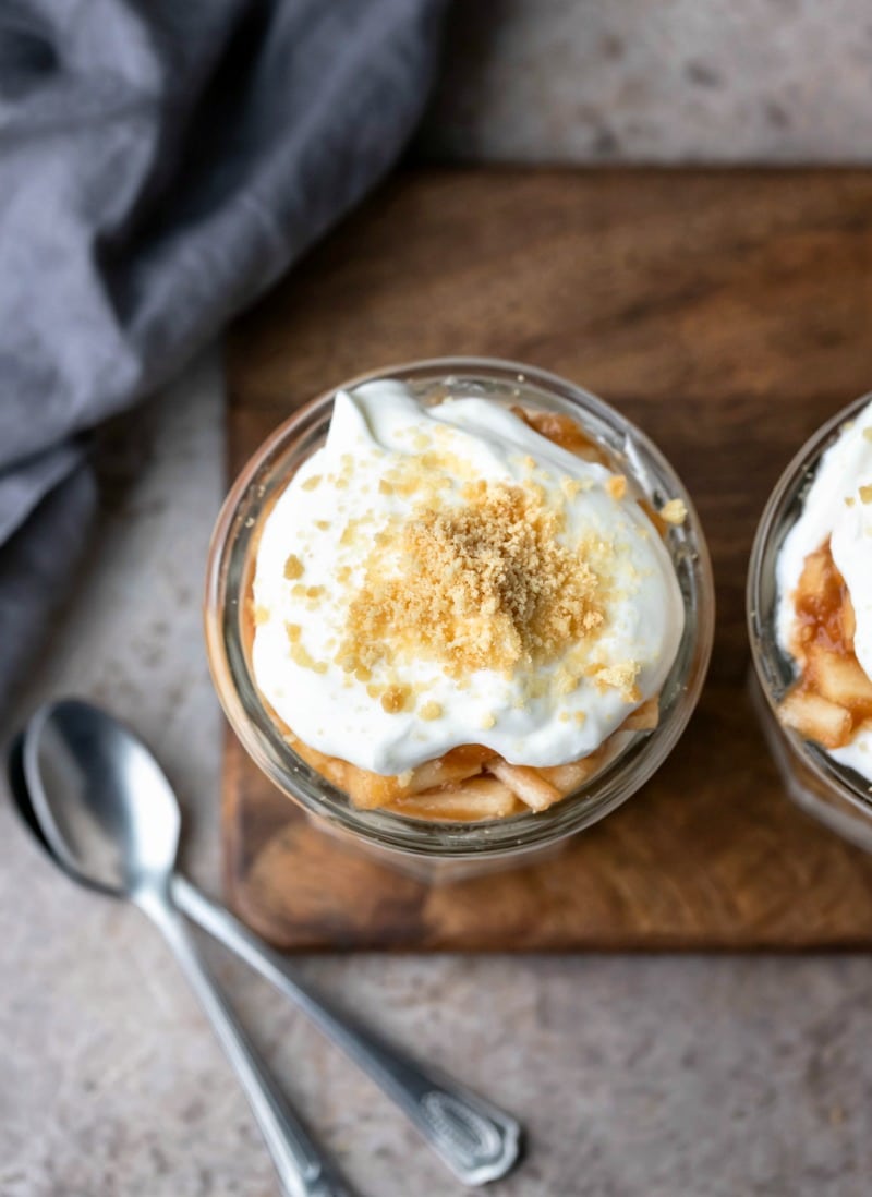 Whipped cream and cookie crumbs on top of an apple pie parfait