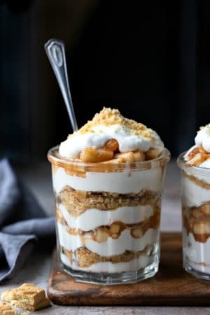 Two no bake apple pie parfaits in a glass jar