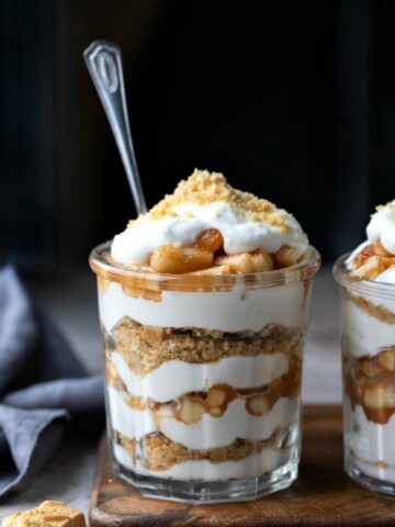 Two no bake apple pie parfaits in a glass jar