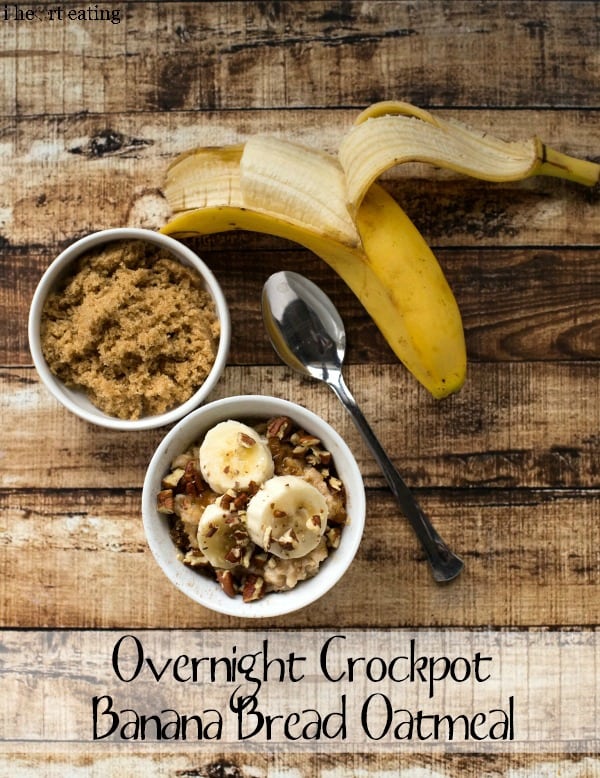 A bowl of Overnight Crockpot Banana Bread Oatmeal next to a spoon, a banana, and a bowl of brown sugar