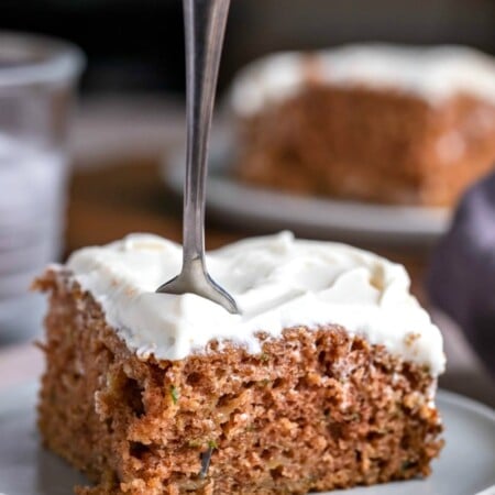 Slice of zucchini cake with a fork stuck in it