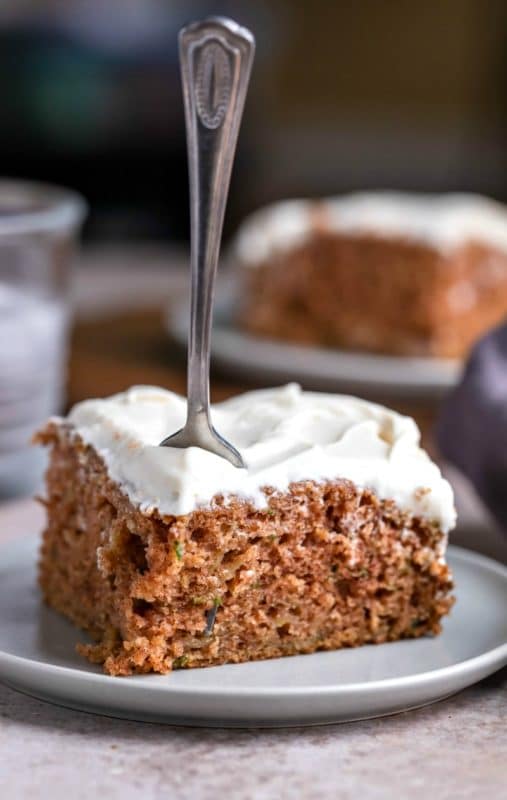Slice of zucchini cake with a fork stuck in it