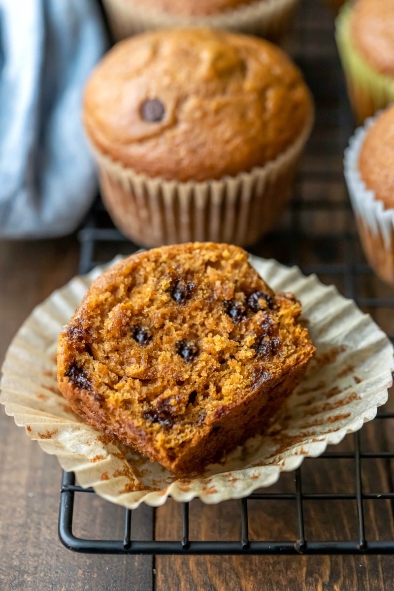 Half of a pumpkin chocolate chip muffin in a muffin liner
