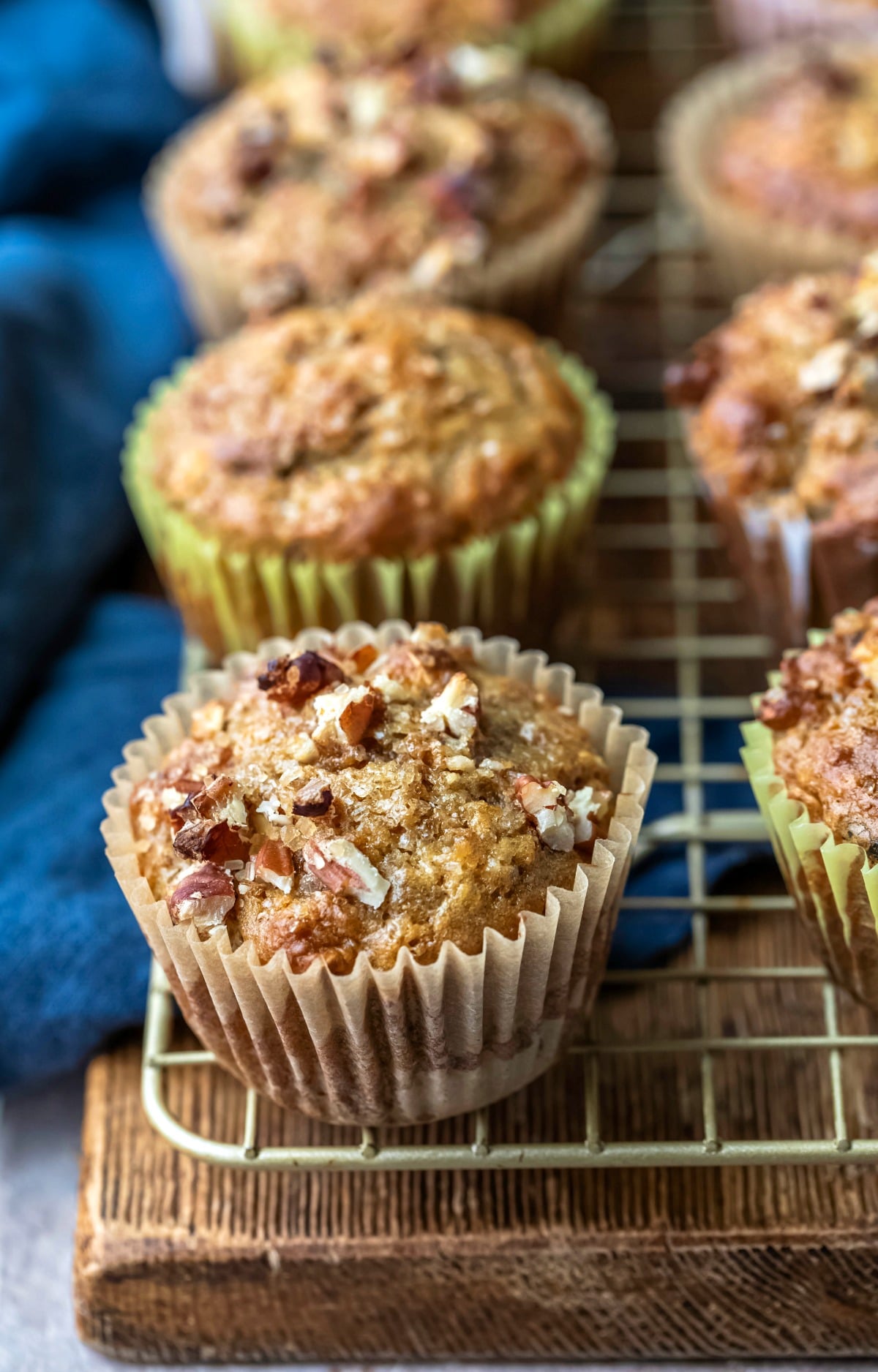 Oatmeal raisin bran muffin topped with chopped pecans and sugar