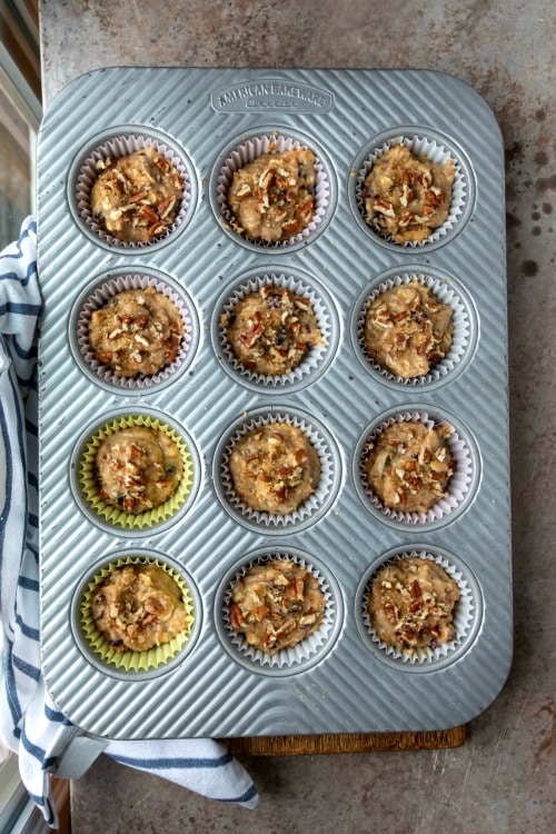 Oatmeal raisin bran muffin batter in a muffin tin