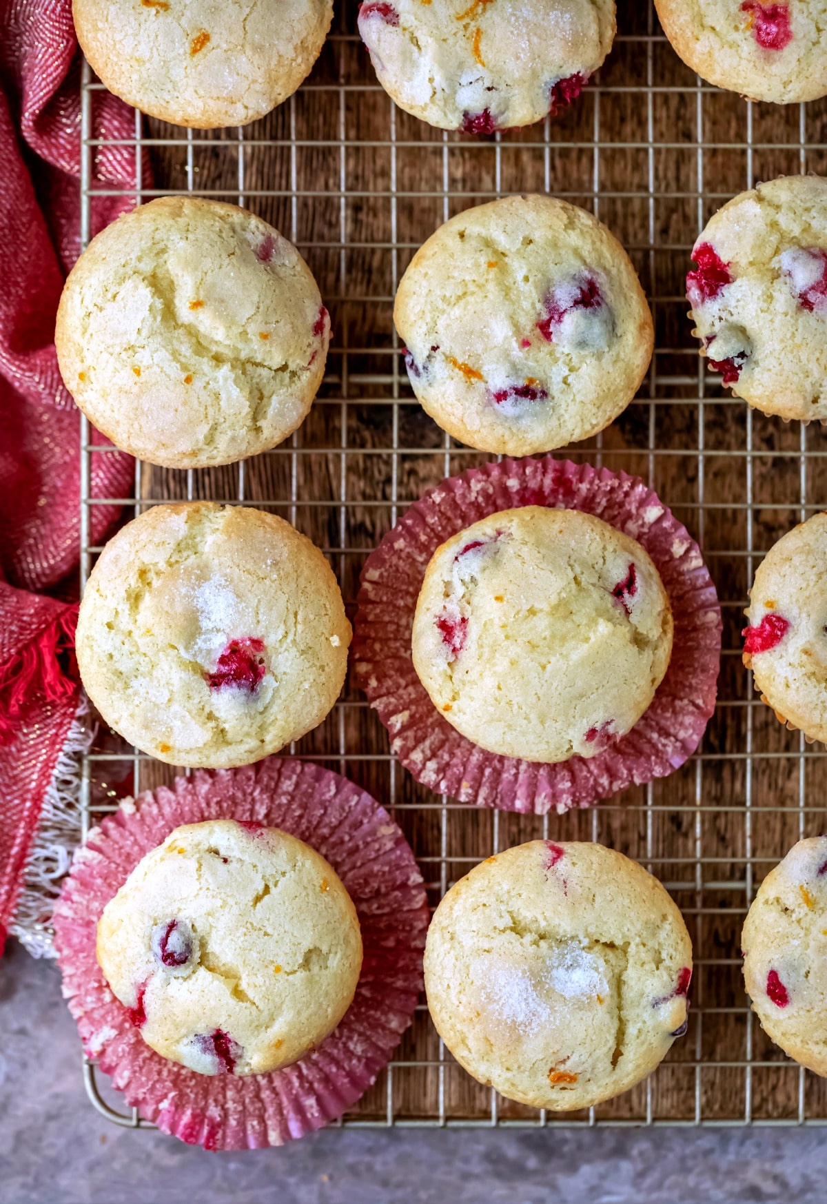 Overhead picture of cranberry orange muffins on a gold wire cooling rack