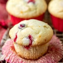 Cranberry orange muffin with the cupcake liner peeled down