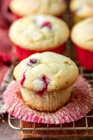 Cranberry orange muffin with the cupcake liner peeled down