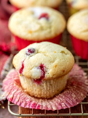 Cranberry orange muffin with the cupcake liner peeled down