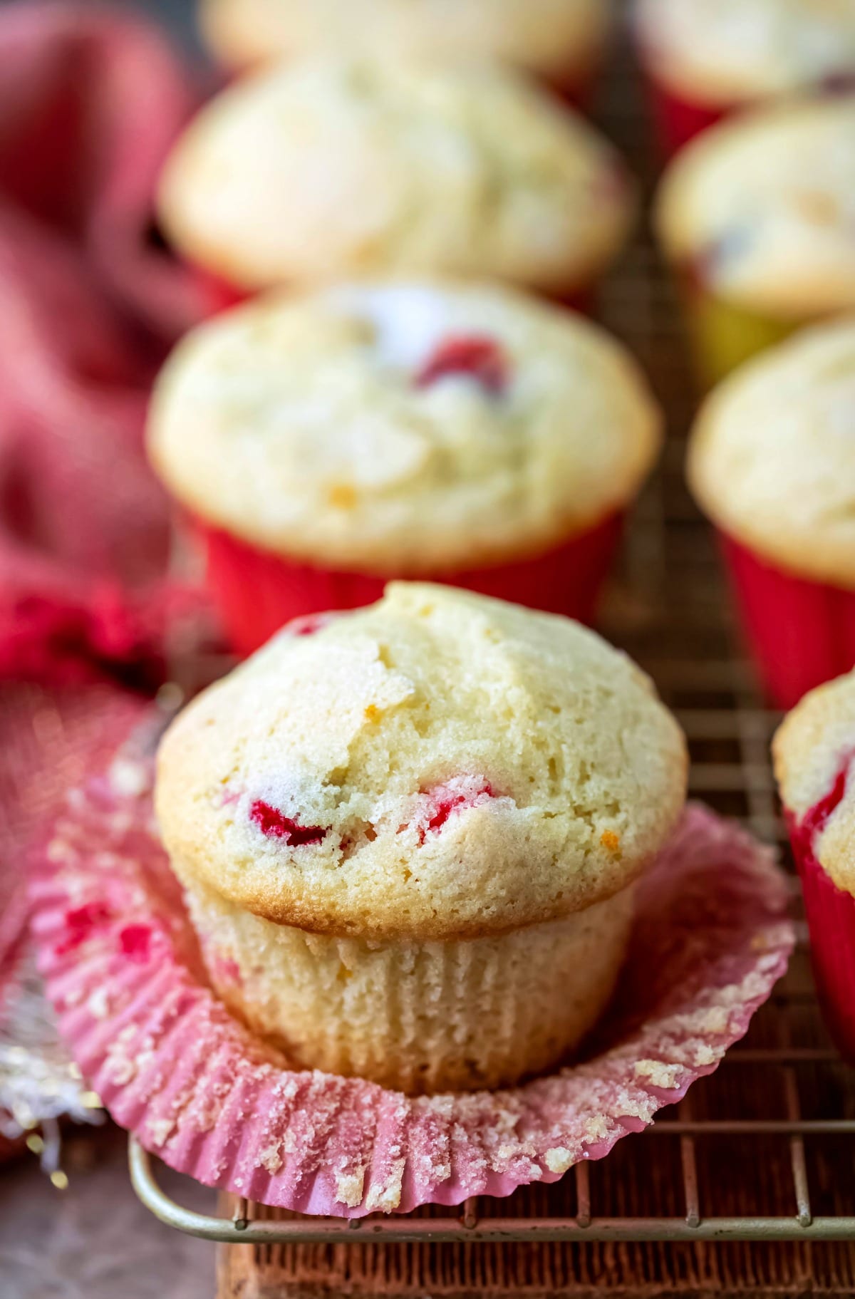 Cranberry orange muffin on a wire cooling rack