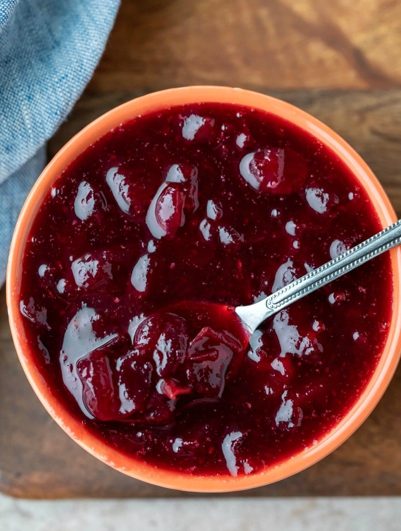 Overhead photo of cranberry sauce with a silver spoon in it