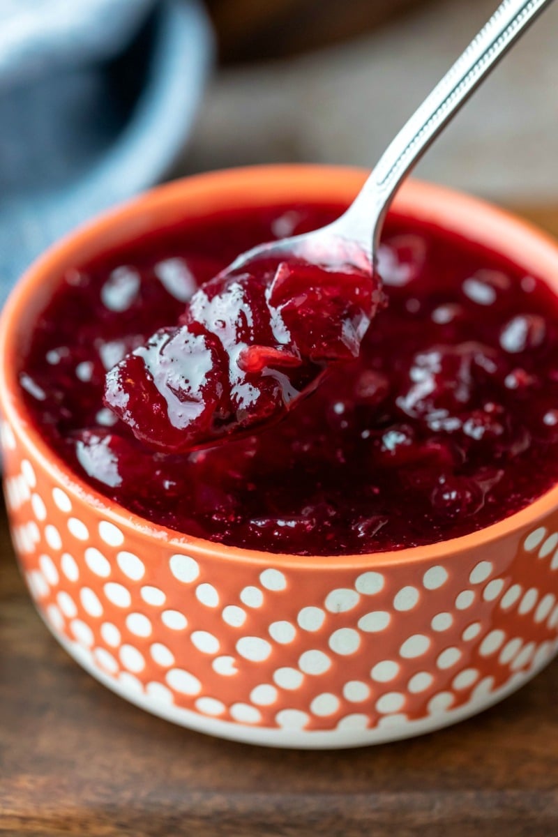 Silver spoon scooping up maple cranberry sauce