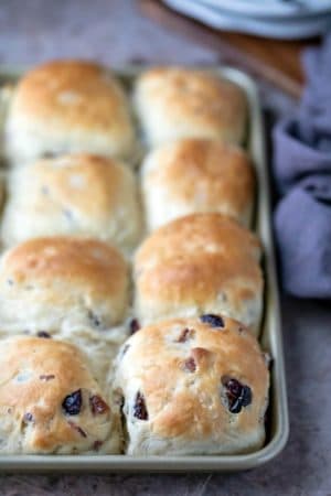 Gold baking pan filled with cranberry wild rice rolls