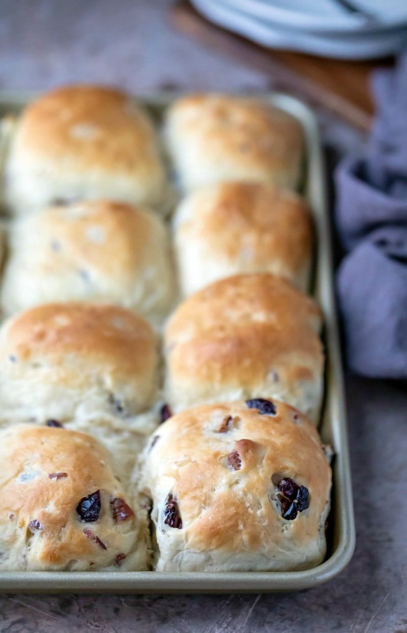 Gold baking pan filled with cranberry wild rice rolls