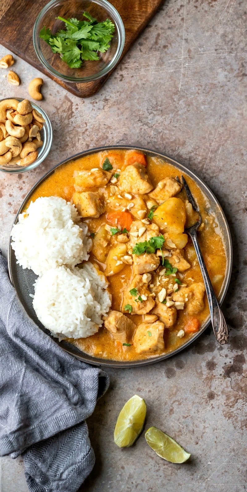 Plate of chicken massaman curry topped with cashews and fresh cilantro