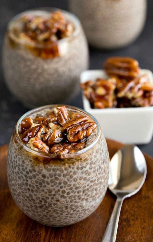 Sticky Bun Chia Seed Pudding in a glass jar next to a spoon