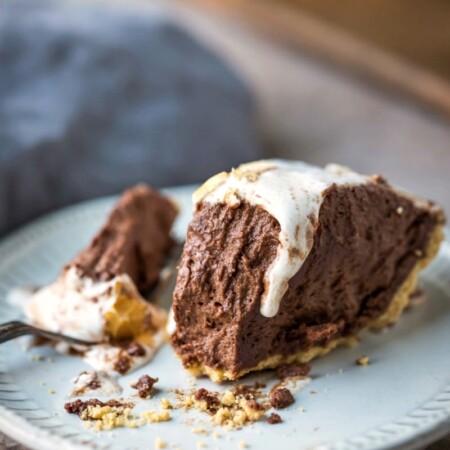 Slice of s'mores pie with a bite next to it on a fork