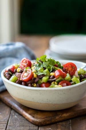 Speckled cream bowl full of black bean salad