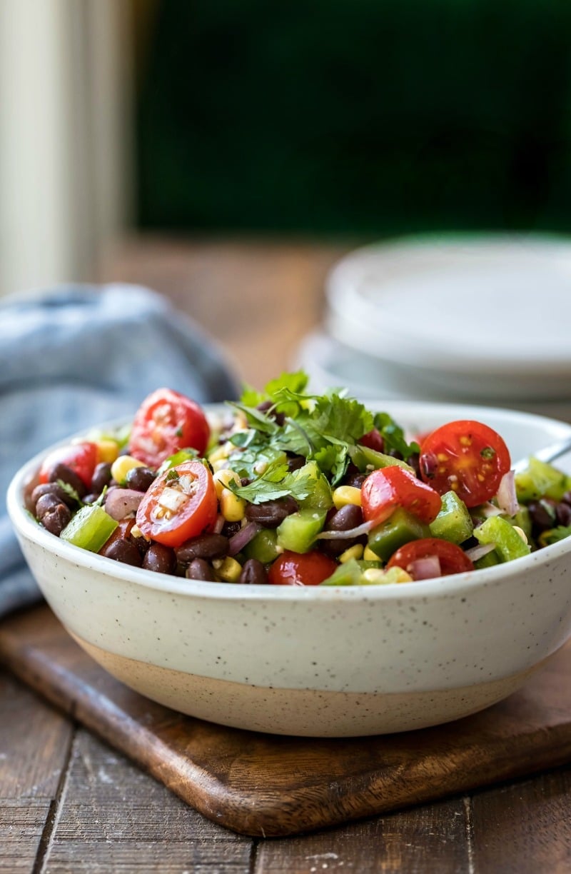 Speckled cream bowl full of black bean salad