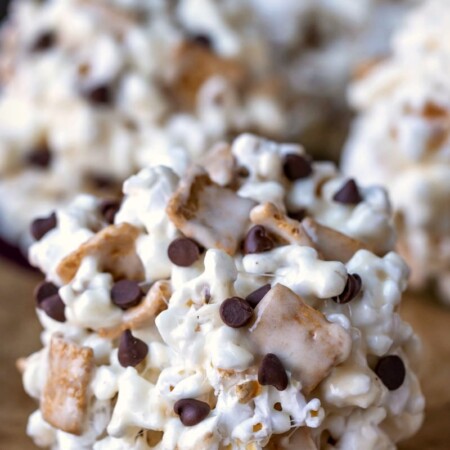 S'mores Popcorn Balls on a parchment lined baking sheet