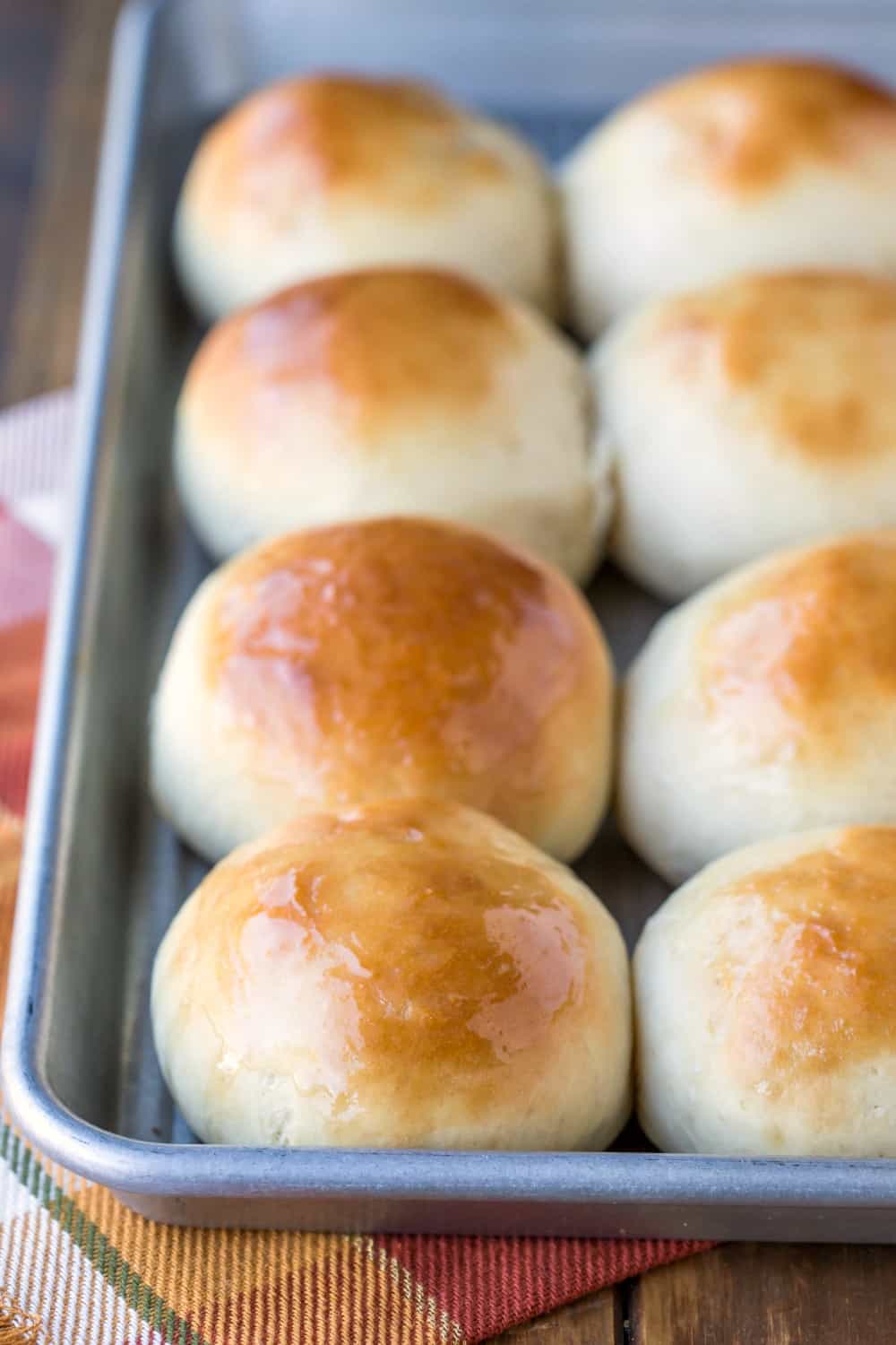 Tray of 30 Minute Buttermilk Dinner Rolls on an orange plaid napkin