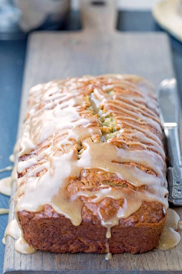 Brown Butter Glazed Banana Bread on a wooden cutting board