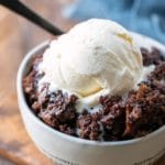 Bowl of Crock Pot Triple Chocolate Bread Pudding topped with vanilla ice cream