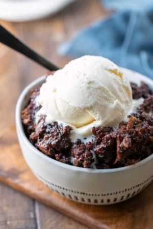 Bowl of Crock Pot Triple Chocolate Bread Pudding topped with vanilla ice cream