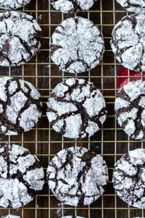 Chocolate Crinkle Cookies on a gold wire cooling rack
