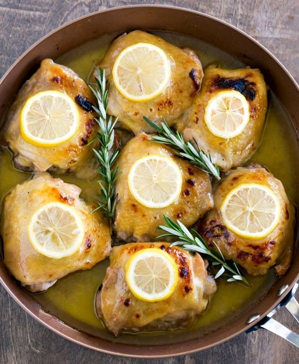 Baked Lemon Honey Mustard Chicken in a pan with slices of lemon