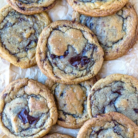 Chewy brown sugar chocolate chip cookies on a piece of brown parchment paper