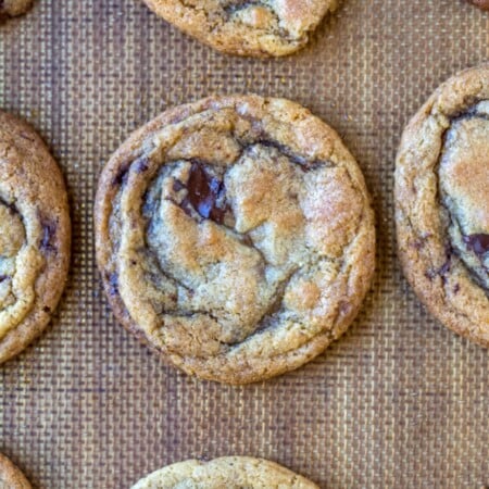 Chewy brown sugar chocolate chip cookies on a silicone baking mat