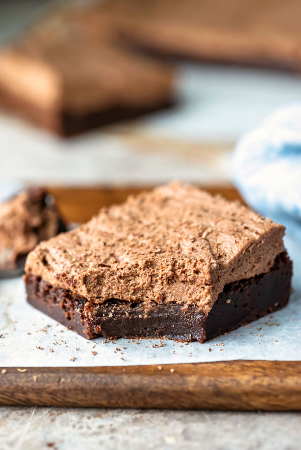 Chocolate mousse brownie on a piece of parchment paper